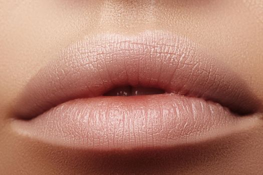 Moisturizing lip balm, lipstick. Close-up of beautiful sexy lips. Full lips with natural lip makeup. Filler Injections