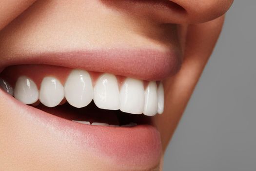 Beautiful smile with whitening teeth. Dental photo. Macro closeup of perfect female mouth, lipscare rutine