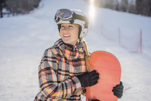 Woman snowboarder on a sunny winter day at a ski resort