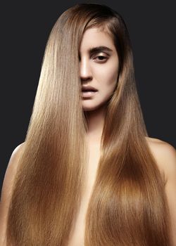 Beautiful yong woman with long Straight brown Hair. Sexy fashion model with smooth gloss hairstyle. Keratin Treatment
