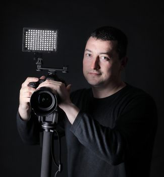 professional photographer with camera on tripod.isolated on black background