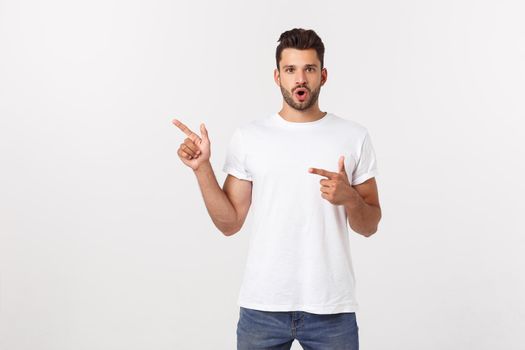 Amazed smart man pointing up at copy space over white background.