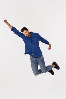 An attractive athletic businessman jumping up against white background