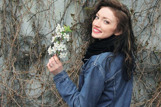 beautiful young woman with a branch of white lilac