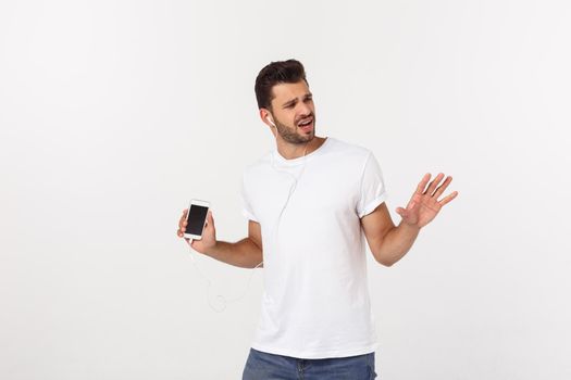Casual handsome man dancing with mobile phone isolated on white background