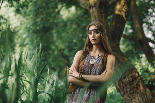 beautiful hippie girl on the background of a forest lake
