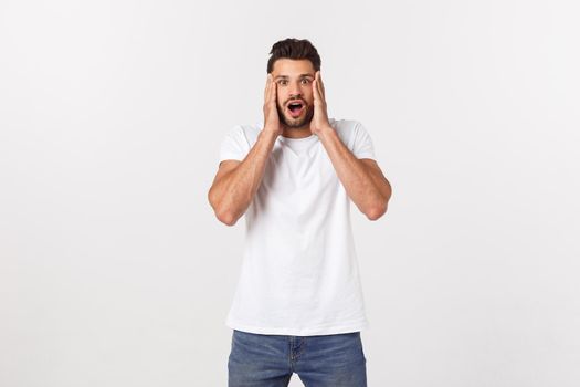 man screaming mouth open, hold head hand, wear casual white shirt, isolated white background, concept face emotion