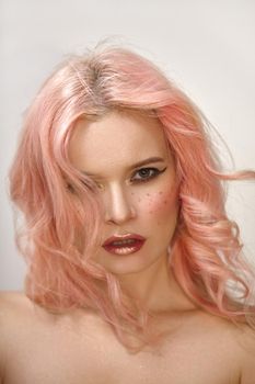 Beautiful woman with curly colored flying hair. Soft Girl style with sexy Make-up, red Lips. Fresh wind of Fashion