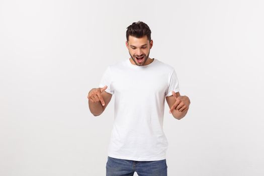 Amazed smart man pointing up at copy space over white background.