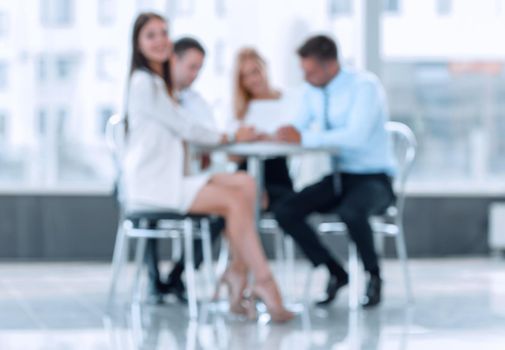 abstract blurred group of business people sitting at a table