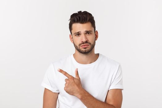 Close up portrait of disappointed stressed bearded young man in shirt over white background.
