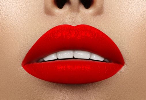 Close-up macro shot of female mouth. Sexy Glamour red lips Makeup with sensuality gesture. Bloody lipstick