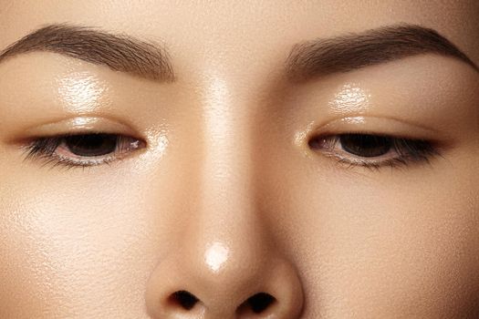 Beautiful female eye with clean skin, daily fashion makeup. Asian model face. Perfect shape of eyebrow