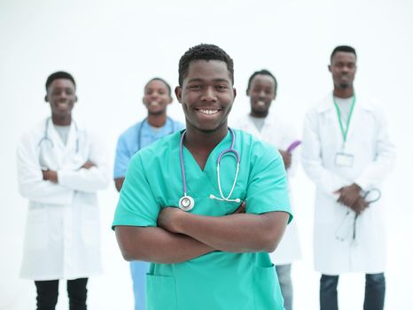 smiling surgeon standing in front of his colleagues