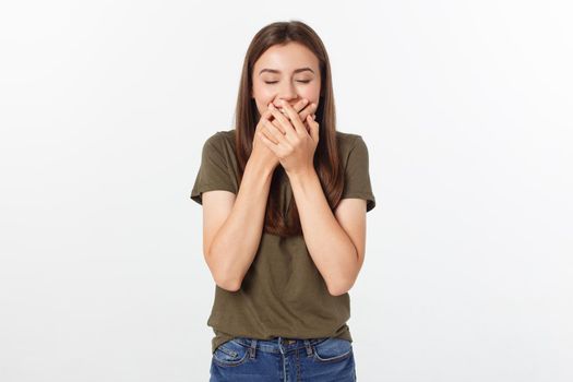 Happy woman laughing covering her mouth with a hands isolate over grey background.