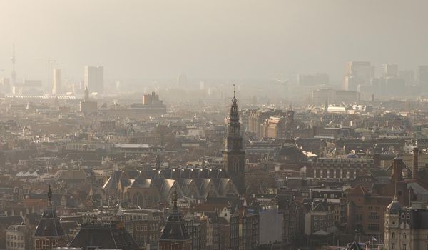 Aerial: Misty cityscape of Amsterdam