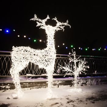 Many Festive Lights Lamps In Shape Deer In Evening Night Festive Illumination.