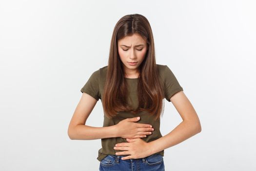 Young beautiful asian woman having painful stomachache on white background.