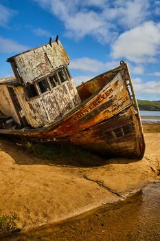 Colorful shipwreck on sandy beach at Point Reyes in California