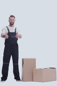 in full growth. friendly man in overalls showing thumbs up
