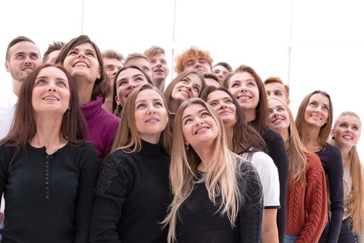 group of happy young people looking up