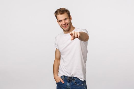 We need you, come here. Attractive and assertive, confident sassy blond guy looking for employees, pointing finger at camera and smiling pleased, found excellent person for company vacancy