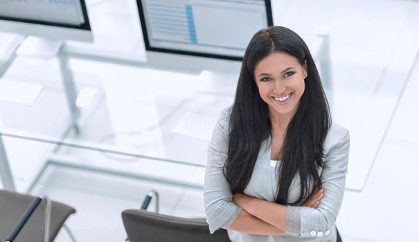 young business woman standing near modern workplace. Photo with space for text