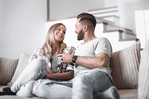 loving couple sitting on sofa in cozy living room
