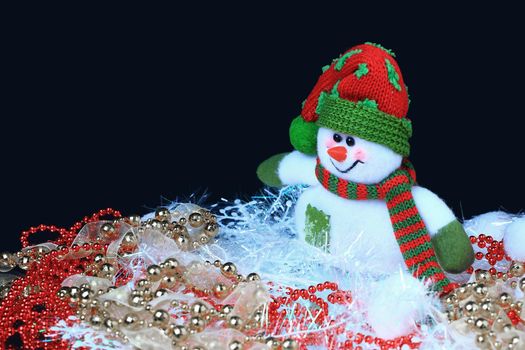 snowman with Christmas decorations on a black background