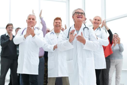 doctors and patients clap their hands. applaud and enjoy success indoors