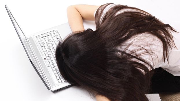 closeup.a young employee falling asleep on the laptop keyboard