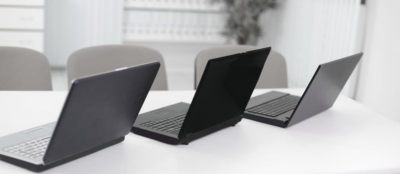 open the laptop on the desktop in a modern office