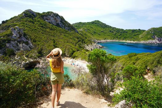 Discovering Greece. Hiker woman enjoying amazing lookout of Porto Timoni on Corfu Island, Greece. 