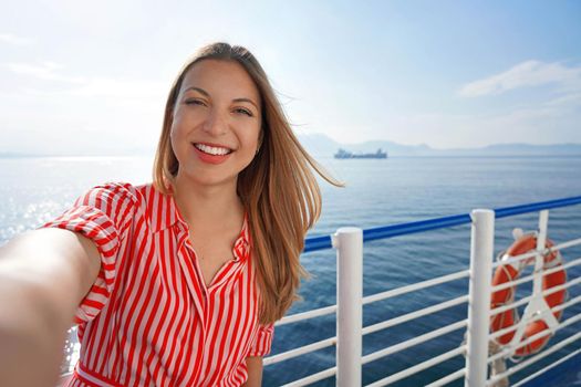 Cruise ship holiday travel vacation. Smiling tourist girl taking selfie on holidays destination on cruise liner.
