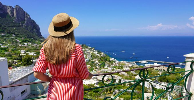 Panoramic banner of fashion woman in Capri Island enjoying landscape from viewpoint, Southern Italy