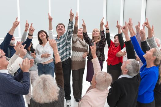 group of happy elderly people show finger