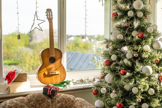 guitar with Christmas presents. Concept image for holiday musical event.