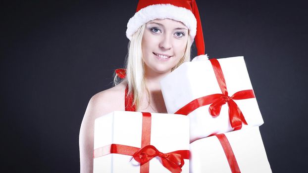 blonde woman in costume of Santa Claus with Christmas shopping.