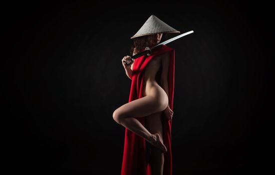 naked slender woman in a red cape and an Asian hat with a katana in her hand image of a samurai
