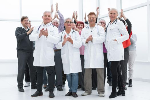 doctors and a group of mature people applaud