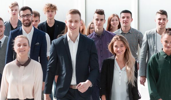 group of ambitious young people walking in a new office