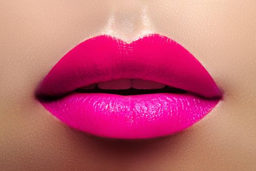 Cosmetics, Makeup. Bright Lipstick on Lips. Closeup of Beautiful Female Mouth with Fashion Pink Lip Makeup. Part of face