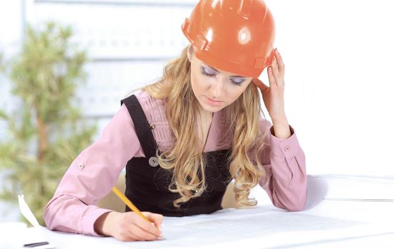 Business woman Drawing Blueprint At Office Desk