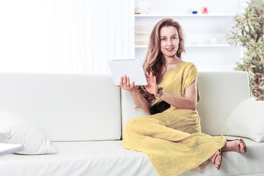 business woman with tablet sitting on the sofa in the nursery