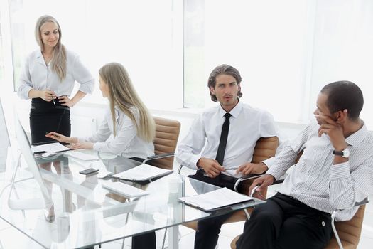 woman presenting her idea to colleagues at meeting