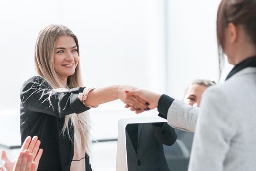 company employees shaking hands at a business meeting