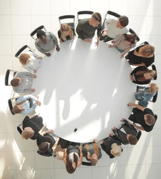 group of diverse young people at a round table meeting