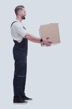 side view. smiling man passing a cardboard box