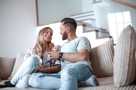 loving couple sitting on sofa in cozy living room