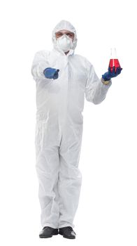 in full growth. a doctor in a biological-protective suit holds a bottle of liquid